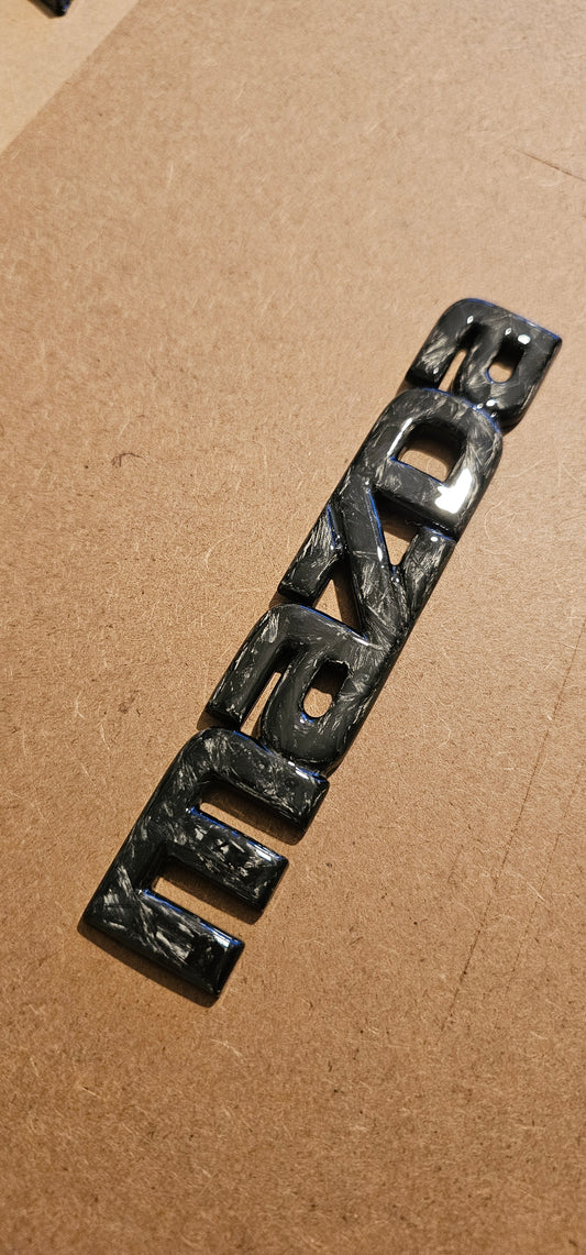 Forged carbon Mazda badge rear